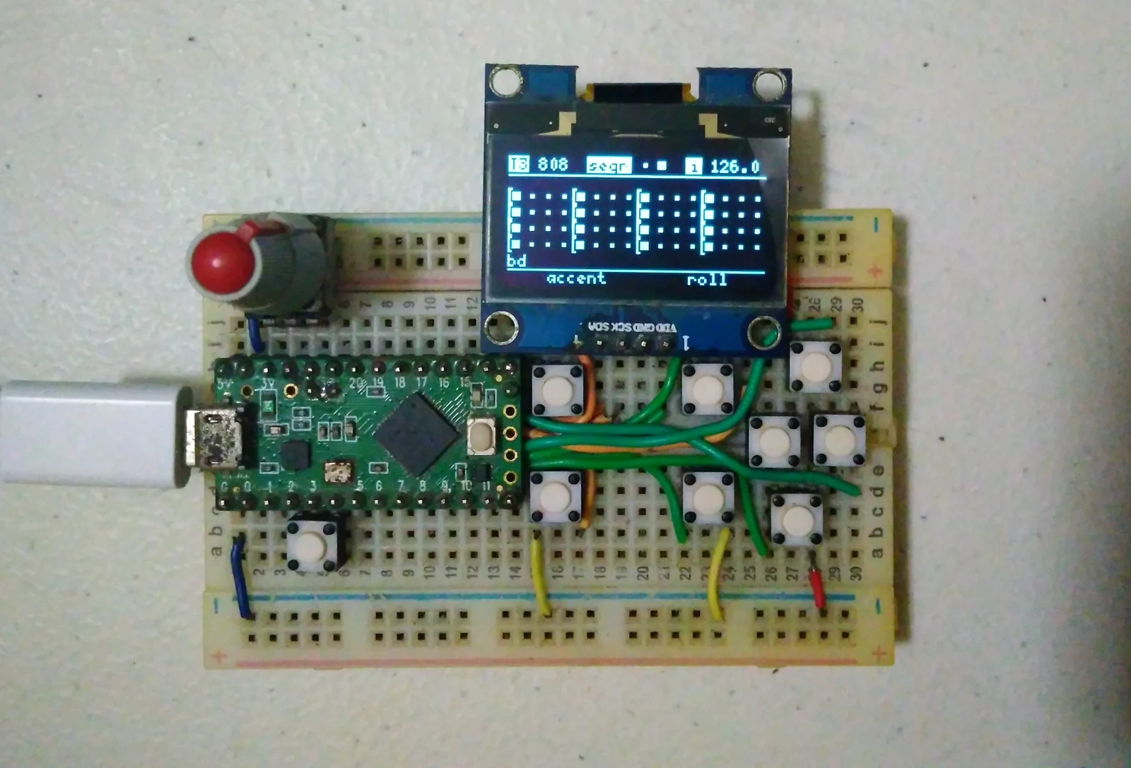 midilab's Aciduino V2 MIDI sequencer assembled on a breadboard with buttons, a knob, and an OLED display