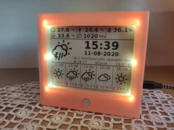 Jakub Jaszczur's orange e-paper weather display with illuminated surround and indoor sensor readings