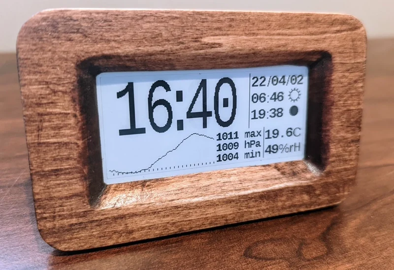 mattwach's completed e-paper clock in a wooden-front enclosure displaying time and local weather readings
