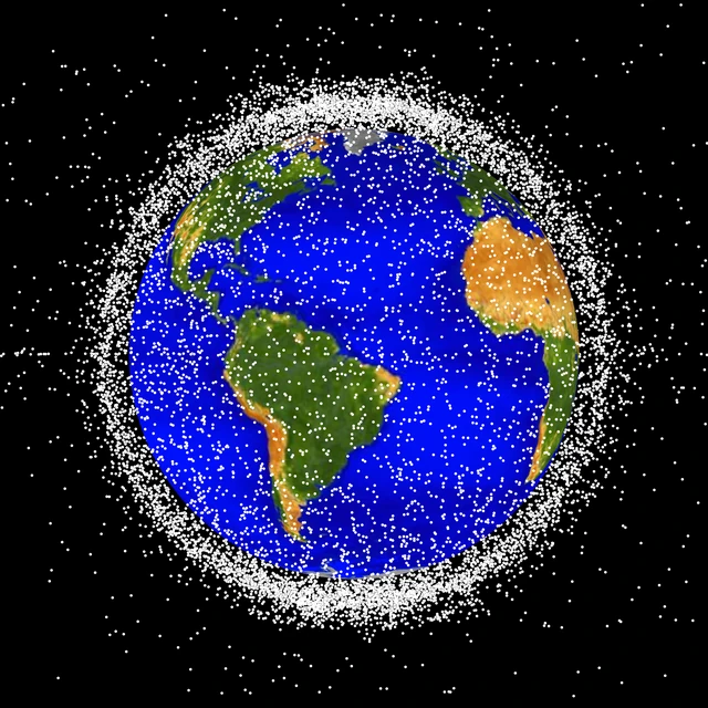 NASA's January 1, 2019 visualization shows cataloged objects in low Earth orbit. The markers are enlarged to make them visible; it is not a current count or a photograph of Meteor 2-7's fragments.