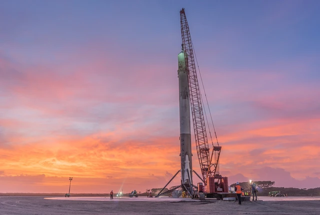 An archival Falcon 9 first stage stands upright at Landing Zone 1 after a return to land. This is earlier hardware, not B1103's October 10 landing.