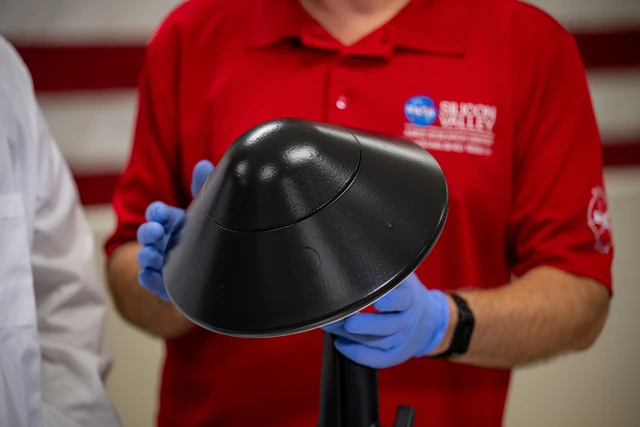 A close-up shows an Ames-produced thermal protection system for KREPE in NASA's STAR Labs. It is a laboratory specimen, not a photograph taken during reentry.