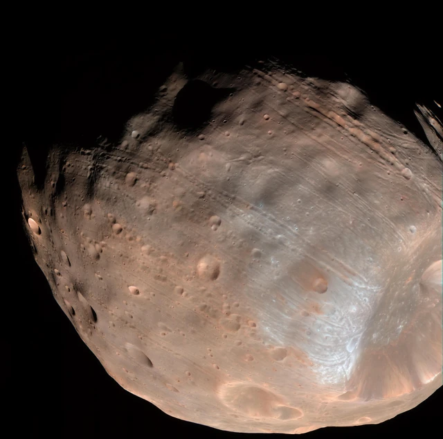 NASA's Mars Reconnaissance Orbiter view reveals Phobos's irregular shape, large crater and densely marked surface