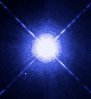 Hubble's archival image of Sirius shows the bright primary and its much fainter white-dwarf companion. This is a different system, not a photograph of the green object.