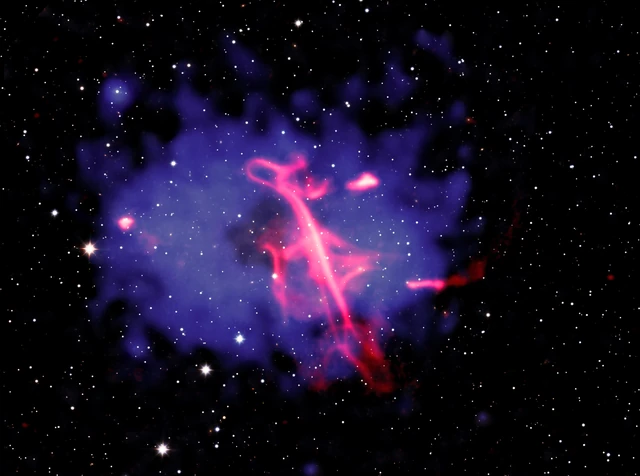 The Treble Clef composite shows a curling pink radio structure inside a blue-purple cloud of X-ray-emitting gas