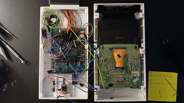 The actual internal hardware reveals why this is a substantial handheld: the CRT, motherboard, controls, and supporting electronics all need physical space.